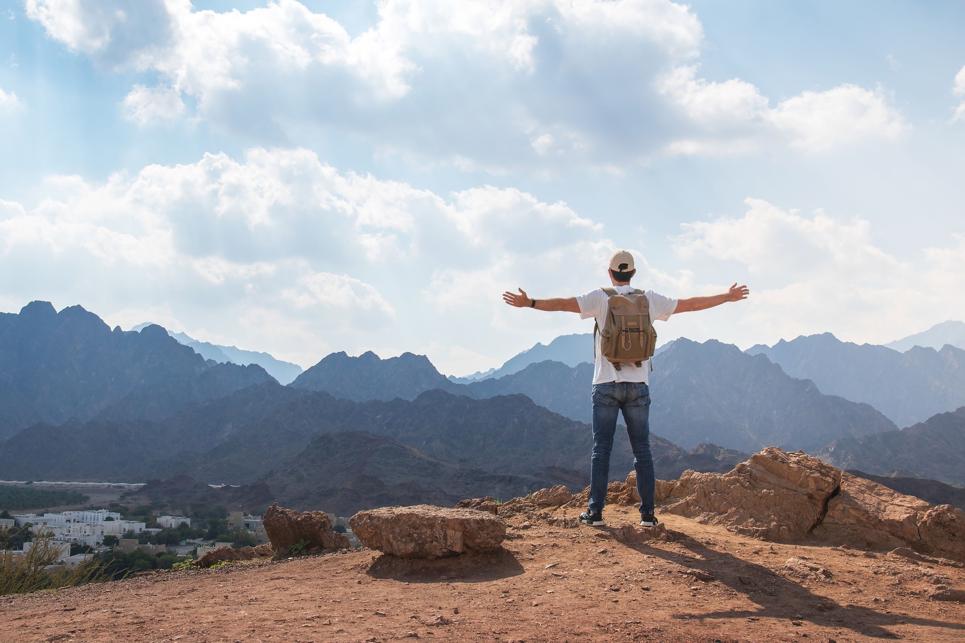 Traveler Embraces Nature in Majestic Landscape of Hatta mountains in Dubai