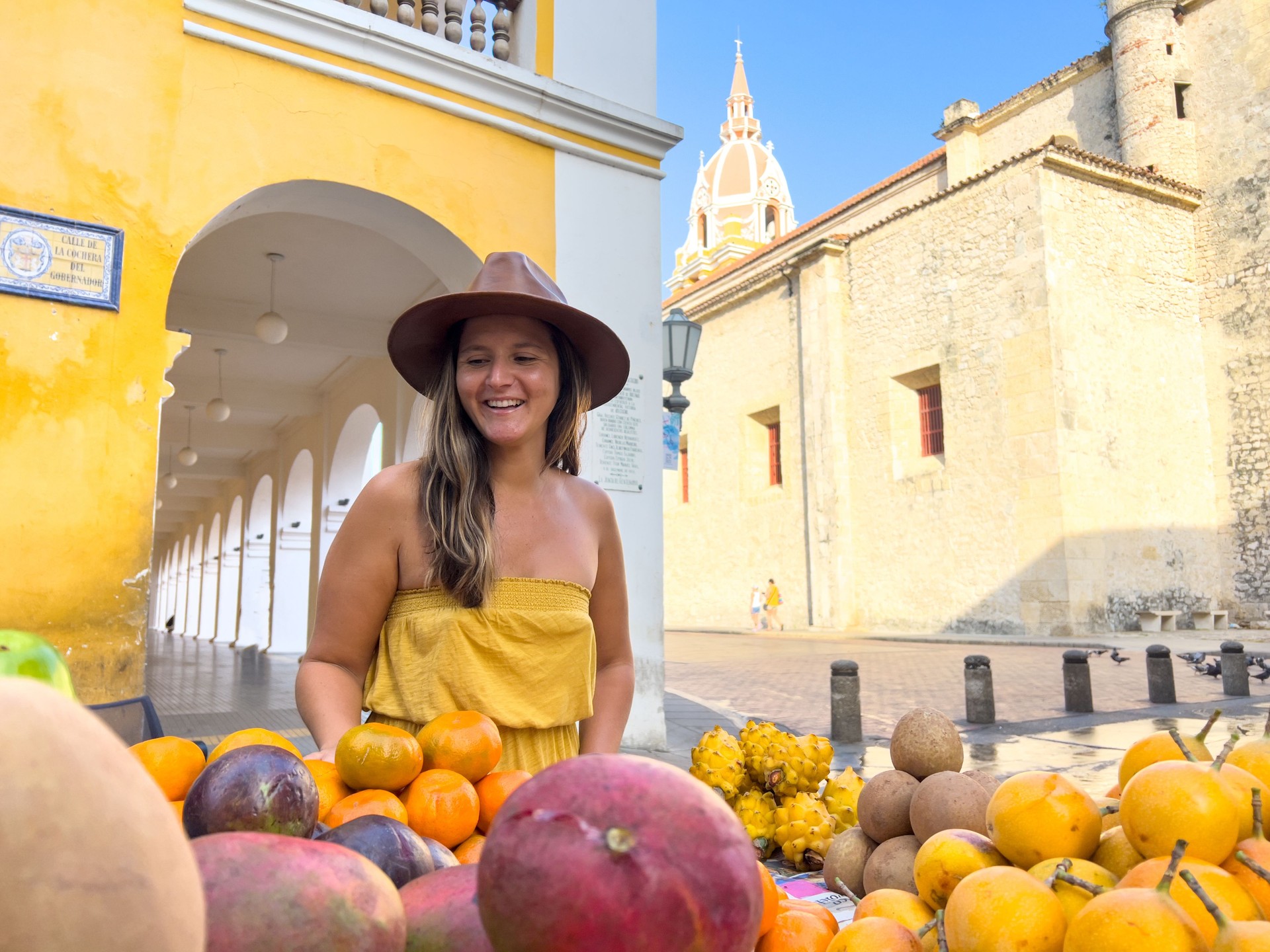 Woman picking fruits at local market in Colombia